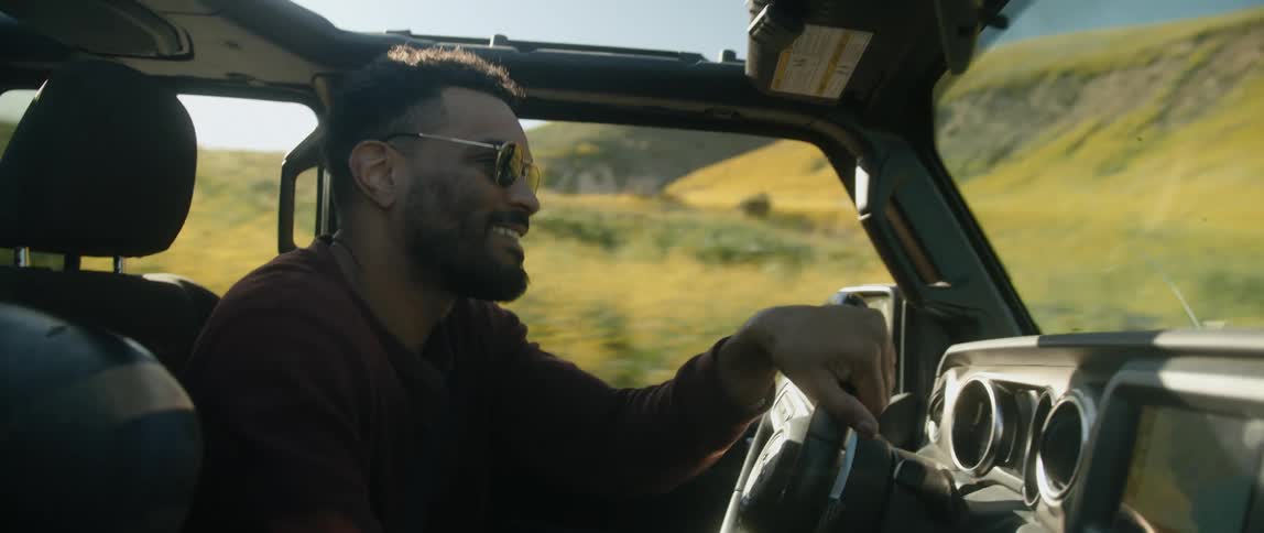 Young man is driving in a vehicle