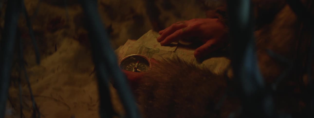 A man is holding a compass and map