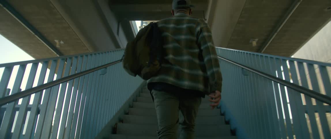 A man travels up the staircase