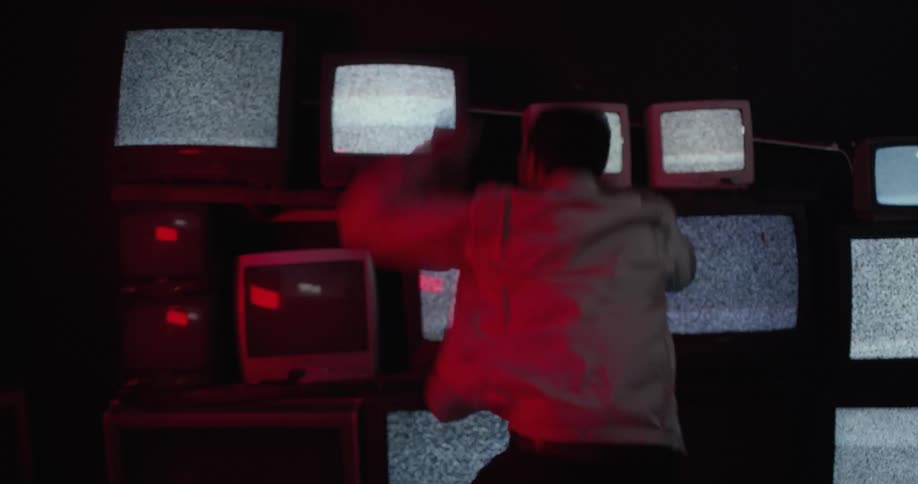 Young teenage boy is in front of the television screaming out loud