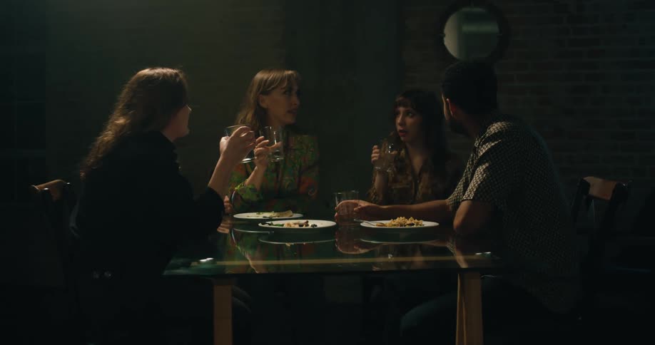 A group of friends are at a restaurant eating together