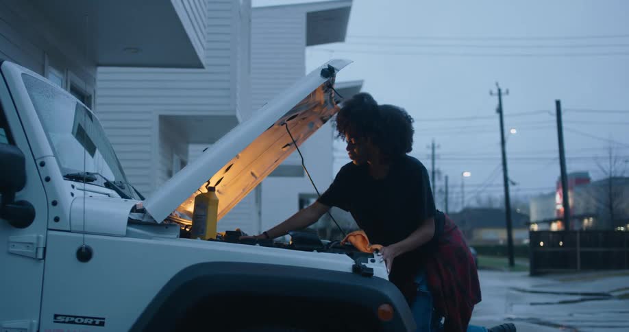 Young woman is fixing a vehicle