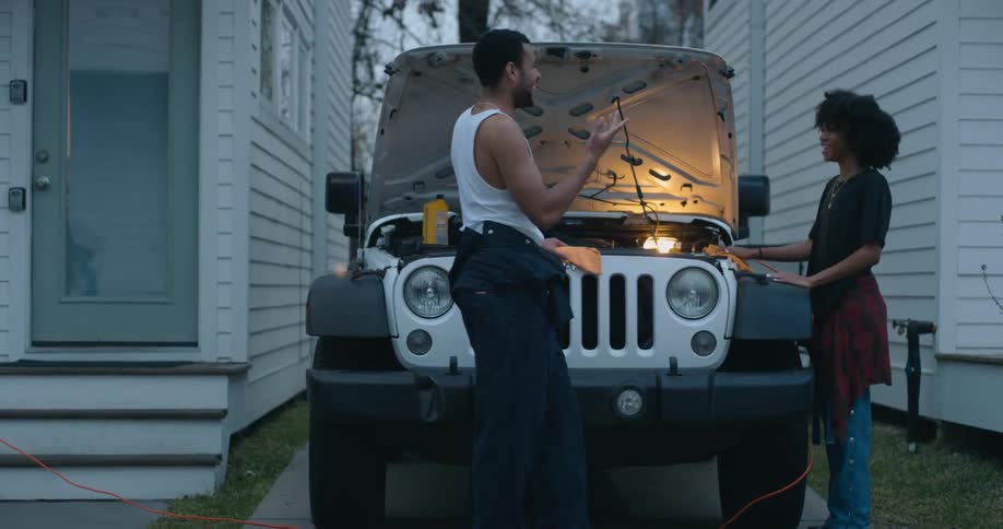 Young woman and man are fixing a vehicle