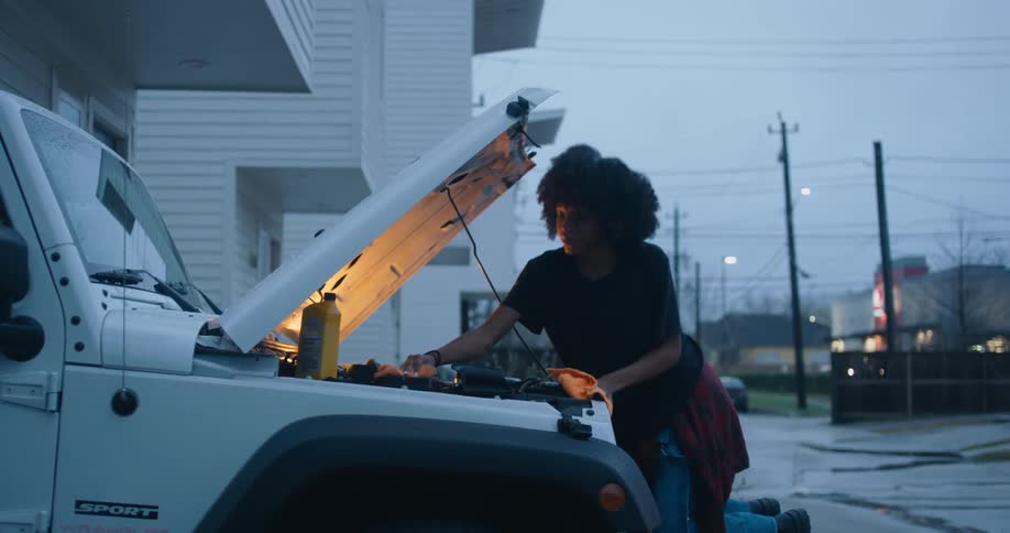Young woman is fixing a vehicle
