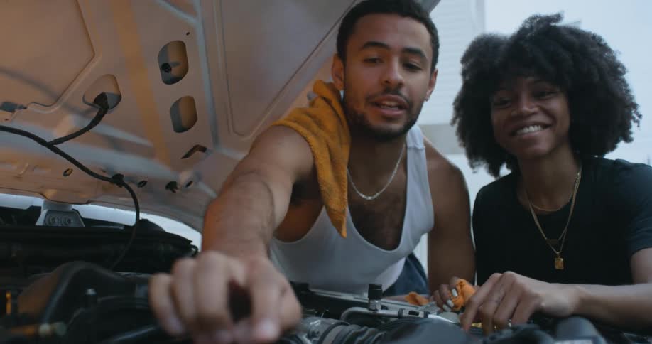 Young woman and man are fixing a vehicle