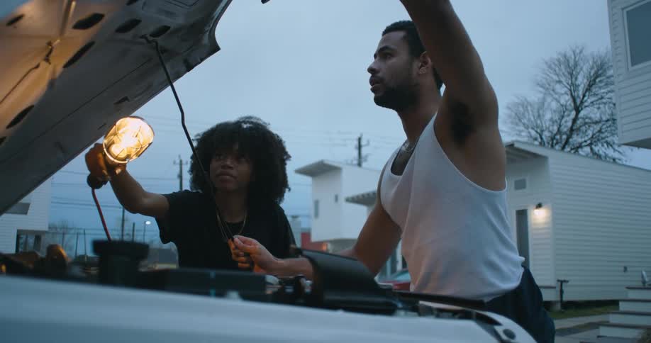 Man and woman are fixing a vehicle