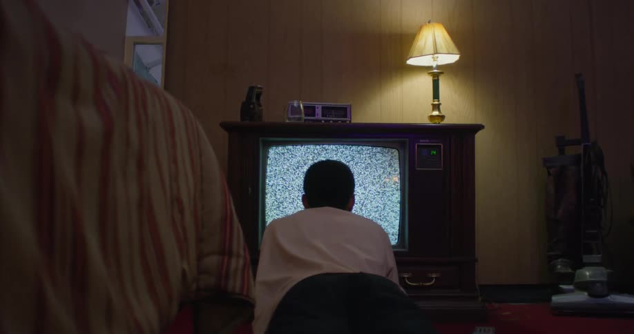 A man sits close to the television