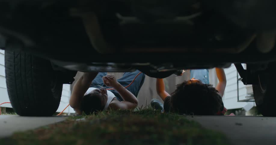 Man and woman are fixing the vehicle