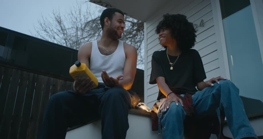 Man and woman are talking outside of their house