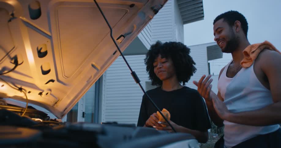 Man and woman are working on a vehicle together
