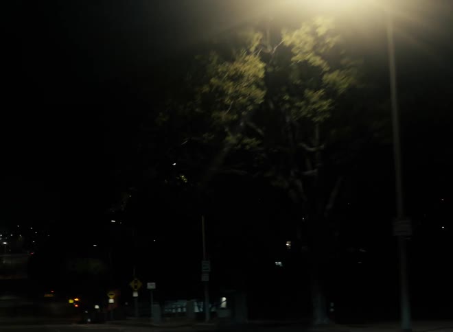 Street lights on the road of a small city at night caught on vintage film