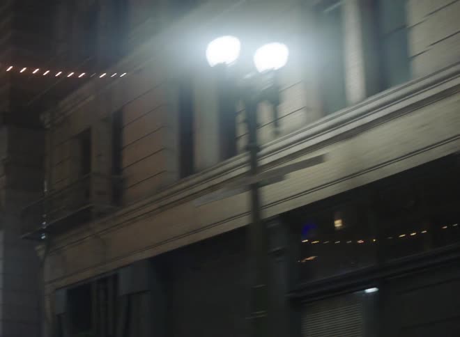 String lights run attached to apartment buildings run across the street
