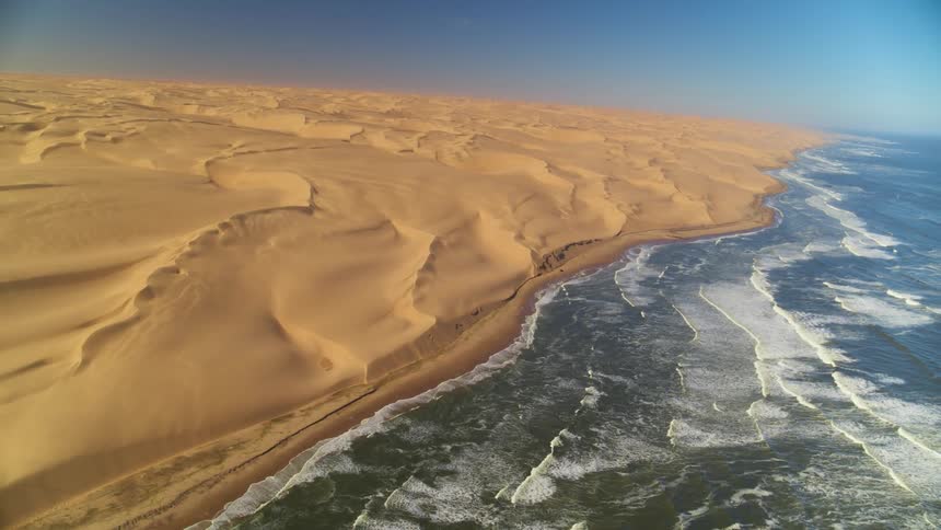 Aerial view of the Namib Desert where the sand dunes meet the ocean