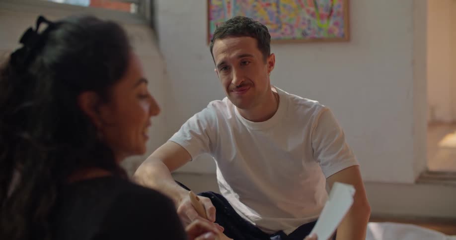 Young man and woman are sitting on the floor