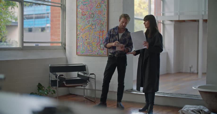 Man and woman are standing up indoors