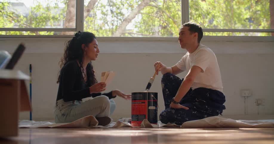 Young woman and man are sitting on the floor
