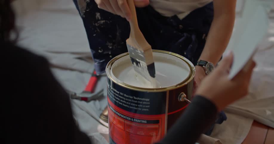 A view of two people getting ready to paint