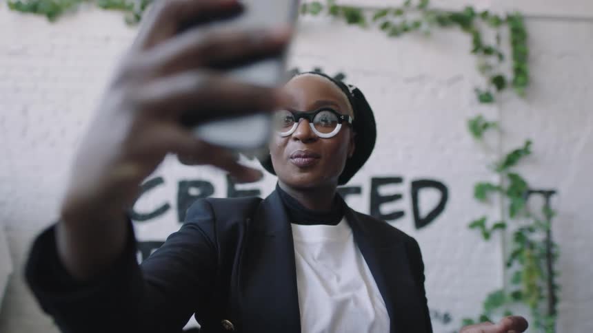 Woman is taking a video indoors