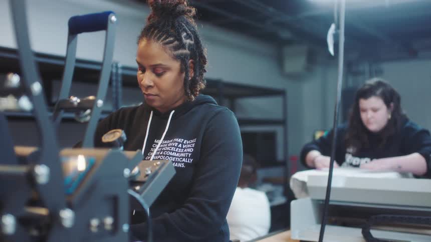 Women work with machines in textile print shop
