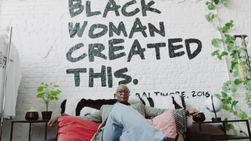 Woman is sitting on a couch