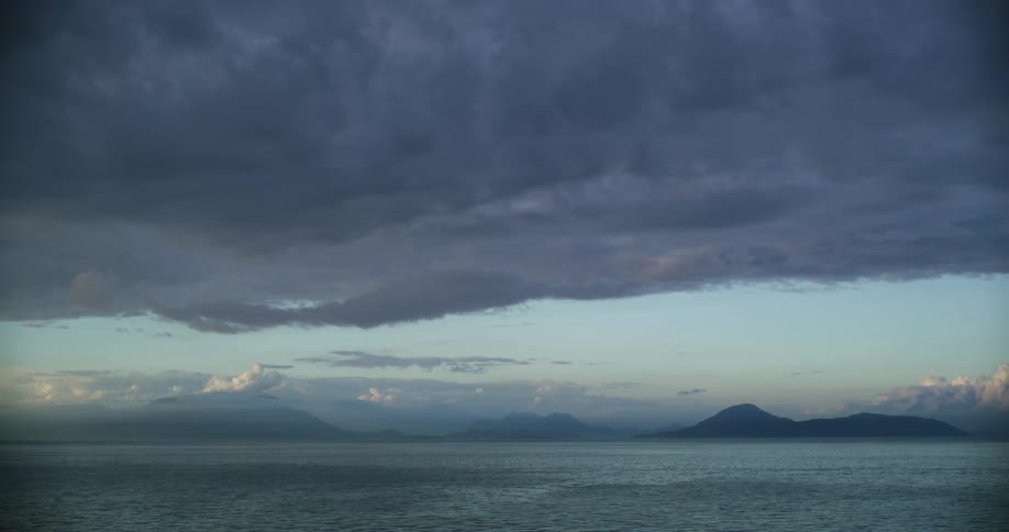Aerial view of ocean water at dusk is displayed