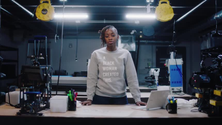 Young woman standing in front of a desk inside a warehouse