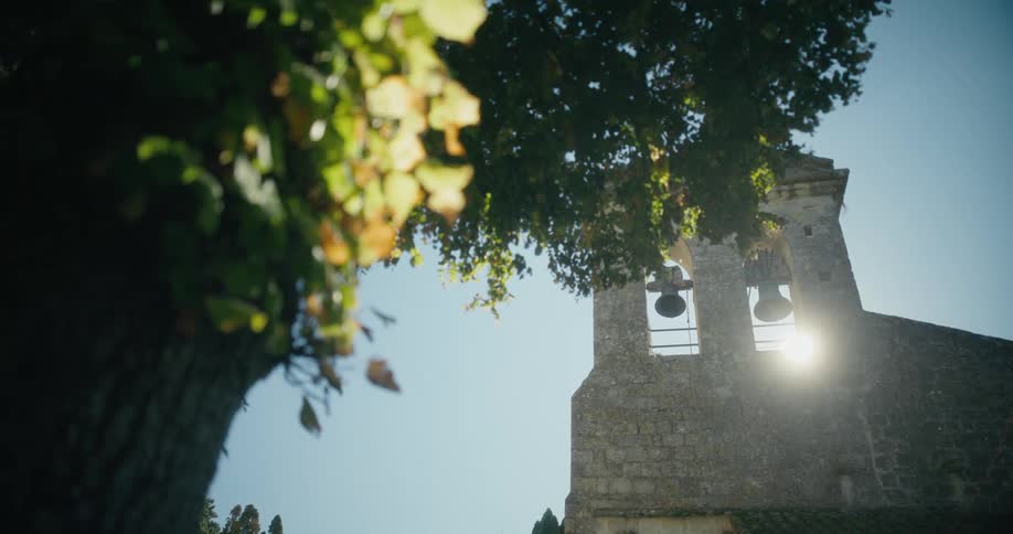 Sun shines through opening in one of two church bell towers