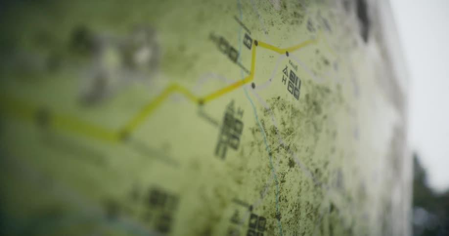 Map showing routes attached to wall outside is moldy and torn