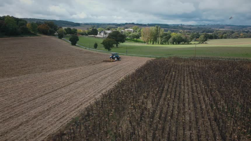 A view of a tractor driving on a farm
