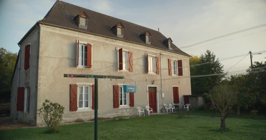 A large house with a red door and window shutters