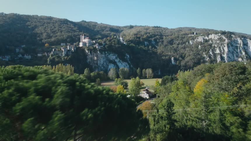 A small town is nestled in and near a valley in the mountains