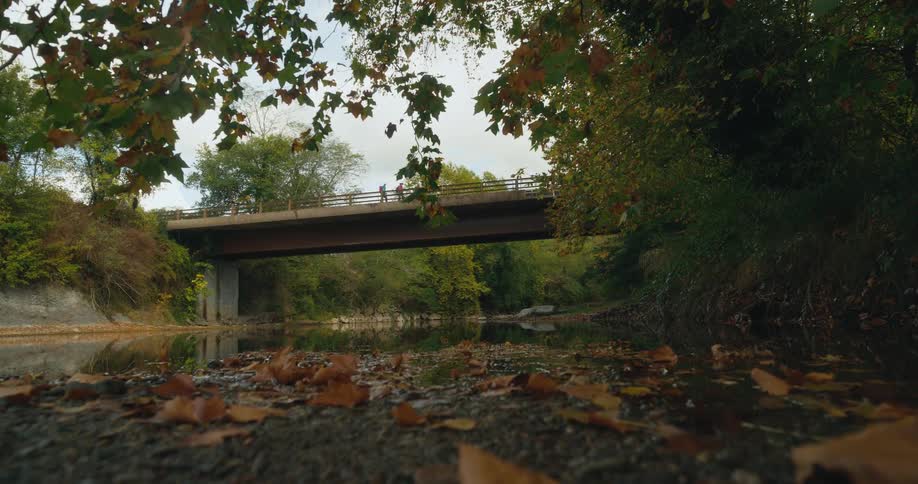 People are walking across the bridge in the daytime