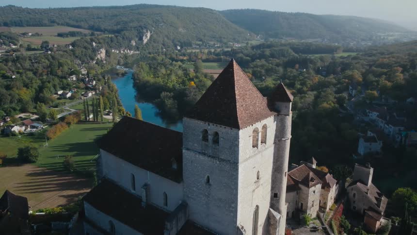 Keep towers over town near river in mist covered valley