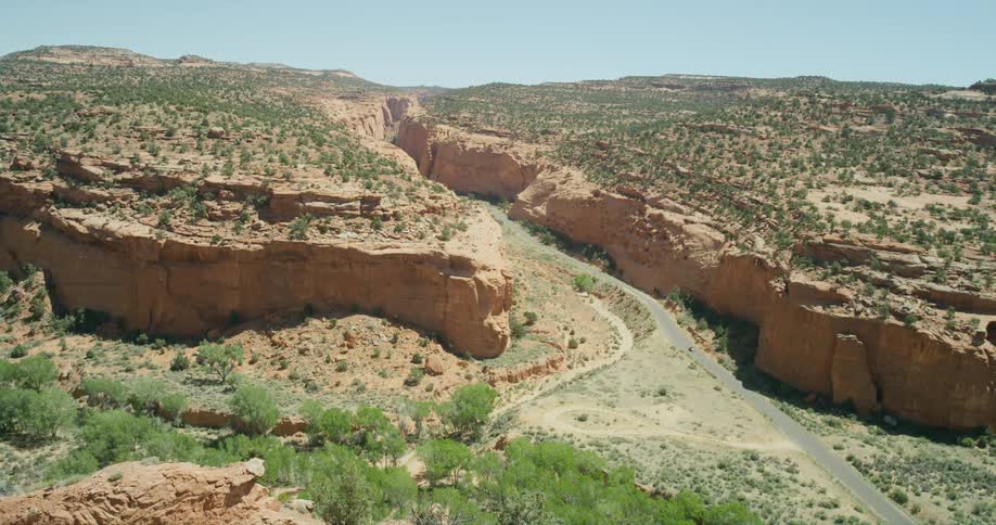 A road through a canyon in the badlands during the day