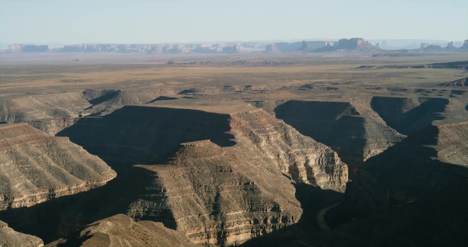 Aerial view of a mountainous area is displayed at dusk