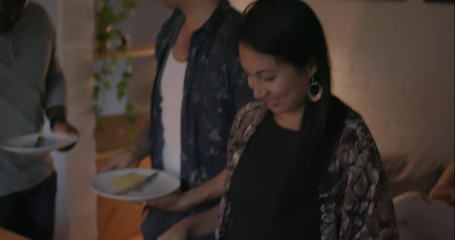 People are lined up to get food from a table
