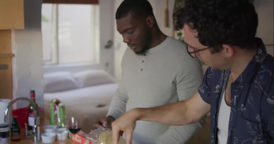 Woman and two men make food together