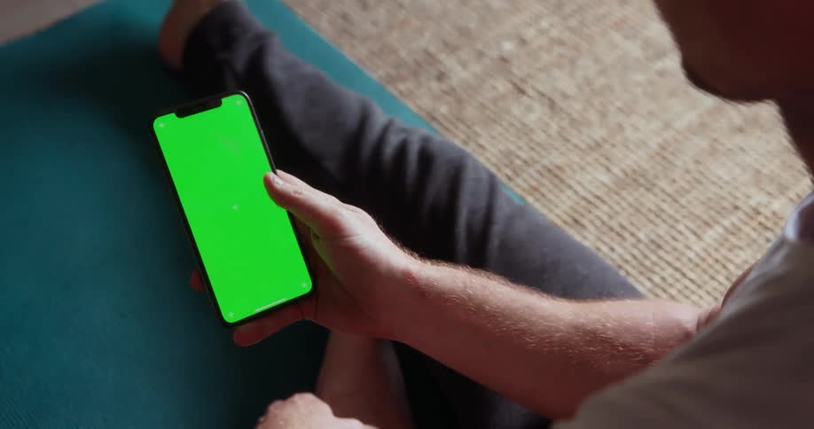 Person taps on their phone with their thumb