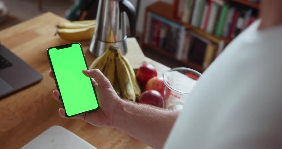 Someone is holding a phone with a green screen on it