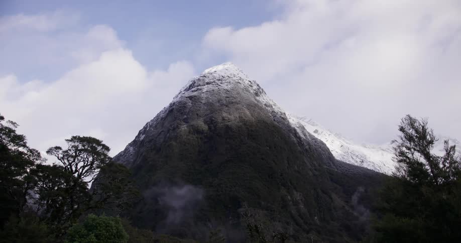 The tall mountain has ice at the top