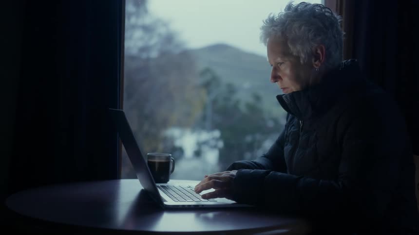 A woman works on a laptop
