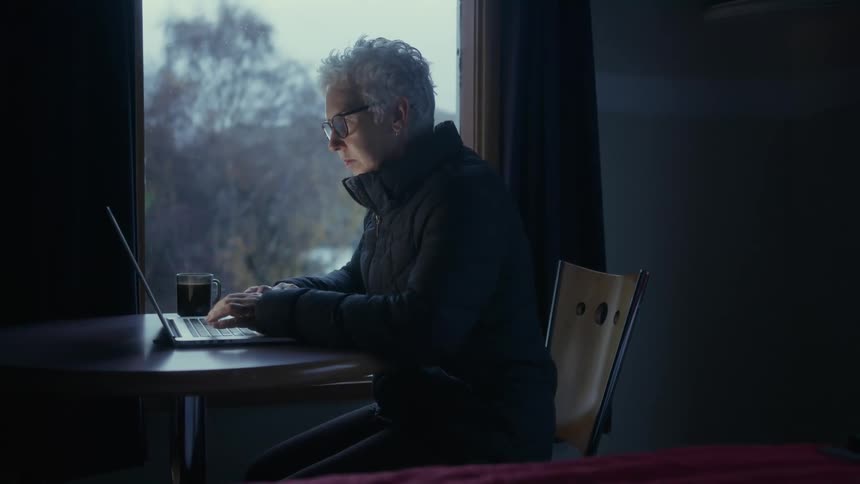 A woman works on a laptop