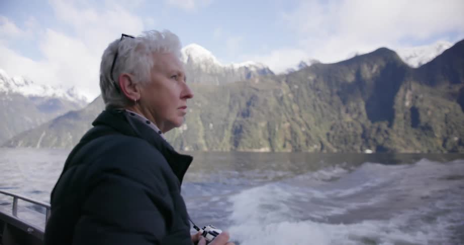 A woman takes pictures from a boat