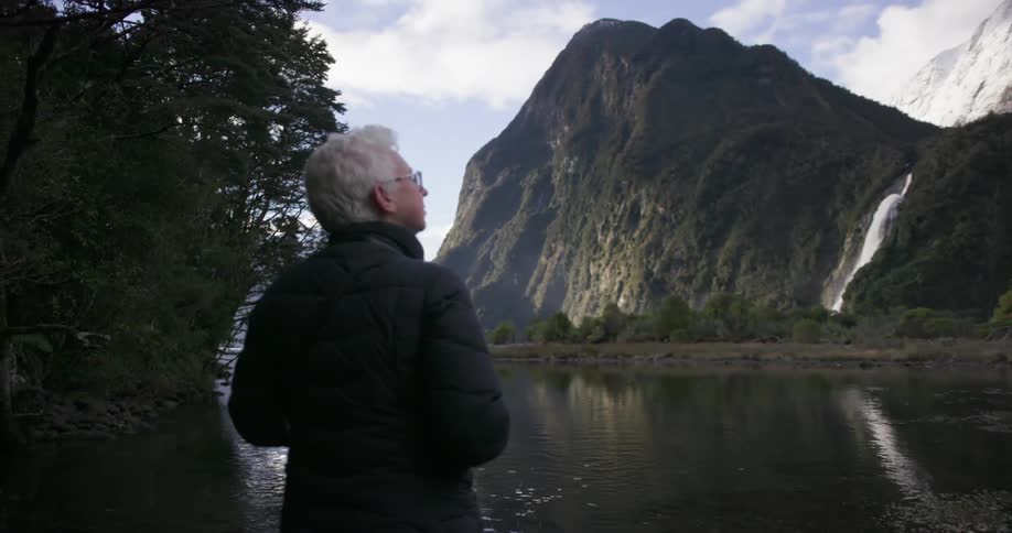 A woman is taking in a view of a lake