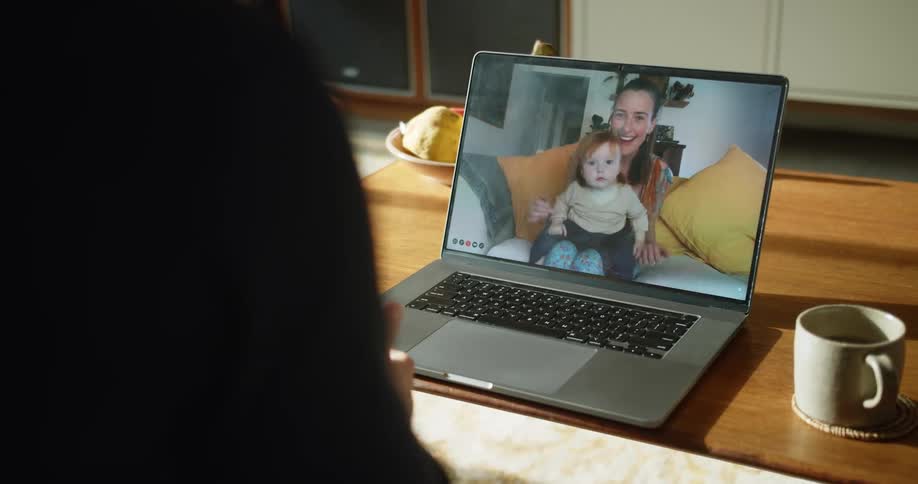 Person having a video call with a woman and a baby
