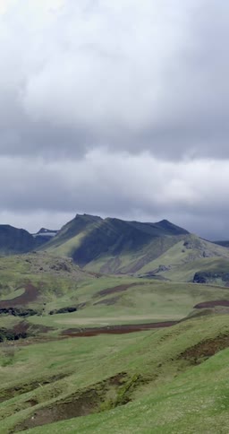 Clouds float over a rural hilly landscape