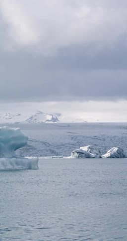 The water moves past the ice covered shore