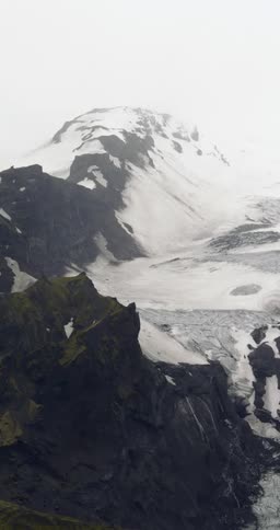 An aerial view of a mountain range is displayed