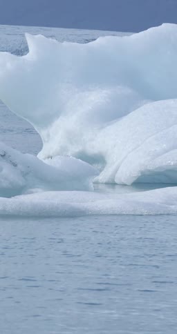 An iceberg on the ocean under a clear sky