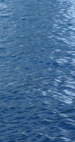 Water forms a wavy pattern as it falls against glass